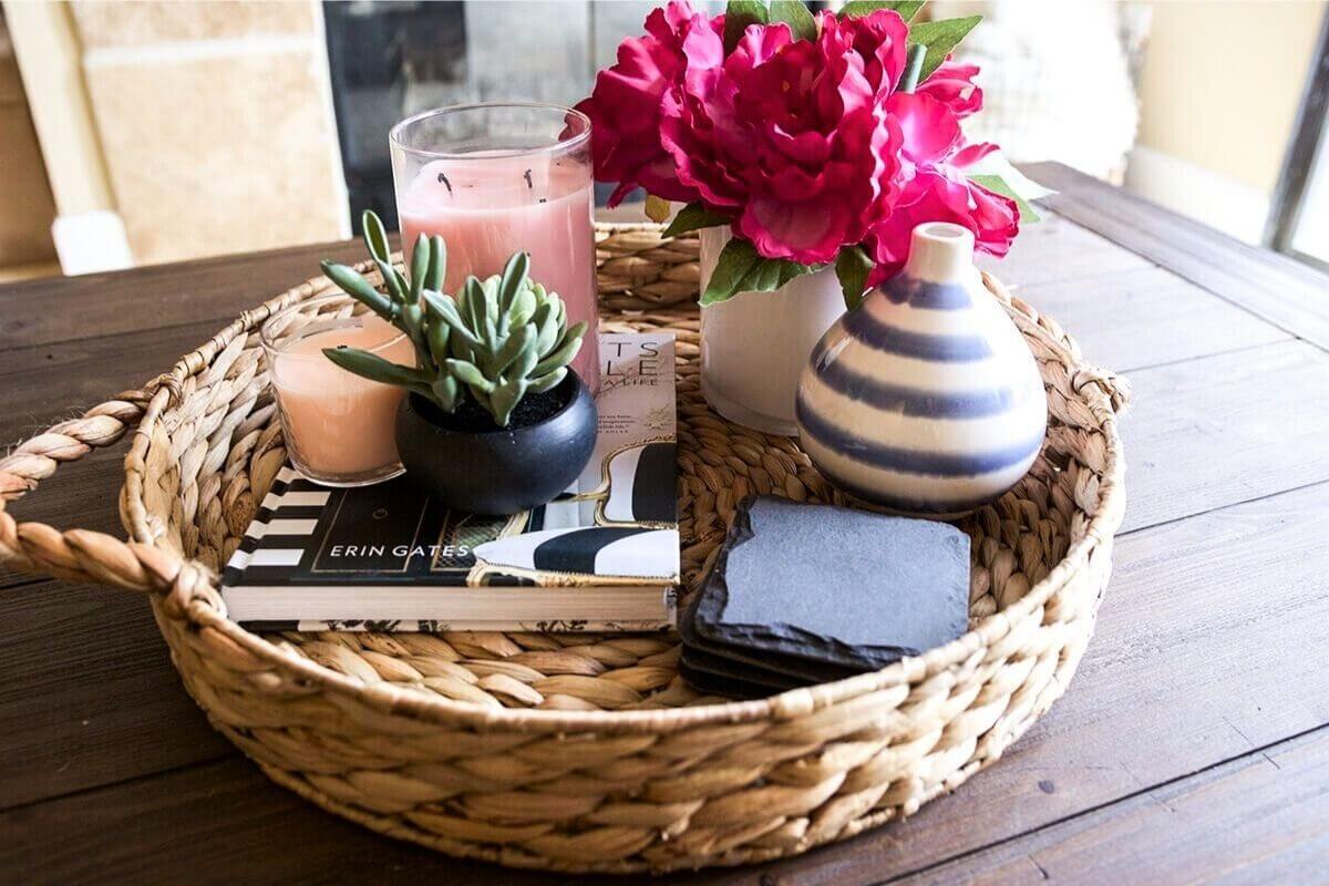 A stylish shelf or side table featuring a few spring-themed objects such as a vase, fresh flowers, and a decorative book.